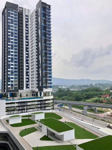 a view of two tall buildings with a green roof at DS15 dsara 50inch 4kTv mrt next Kota Damansara in Sungai Buluh