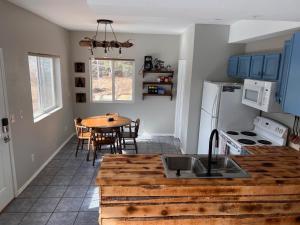 a kitchen with a wooden counter top and a table at Red Door cabins in Florissant