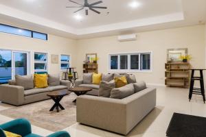 a living room with two couches and a table at Welcome to our Ocean View Villa! in Lucea