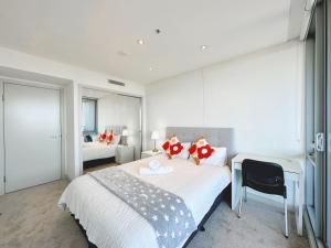 a white bedroom with a bed and a desk at Share House Master Room Near Chatswood Station in Sydney
