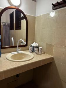 a bathroom with a sink and a mirror at Hotel Maya Luna Adults Only in Mahahual