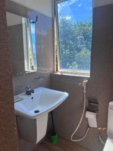 a bathroom with a sink and a window at Beach Paradise in Matara