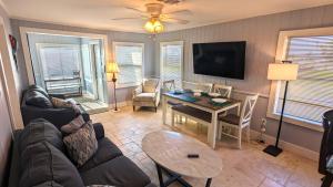 a living room with a couch and a table at 213 Ohio in Fort Myers Beach