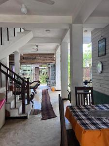 a living room with a bed and a staircase at Beach Paradise in Matara
