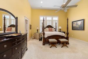 a bedroom with a bed and a dresser and a fan at Beachview 913 in Saint Simons Island +27 photos