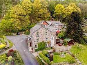 an aerial view of a large stone house with a driveway at 1 bed in Eskdale SZ503 in Beckfoot