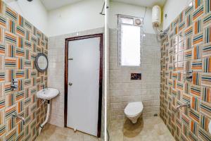 a bathroom with a toilet and a sink at FabHotel The Hastings Club in Kolkata