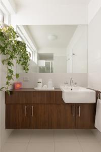 a bathroom with a sink and a mirror at MAC St Kilda by Melbourne Apartment Collection in Melbourne