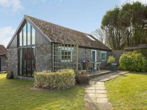 a stone cottage with a garden and a patio at 2 Bed in Wells 00452 in Binegar