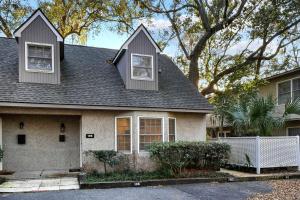 a house with three windows and a roof at Oceanwood 106 in Saint Simons Island