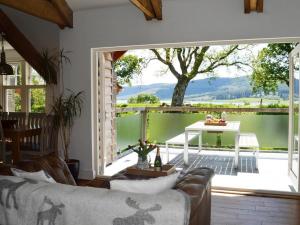 a living room with a couch and a large window at 5 bed in Colintraive 74117 in Colintraive