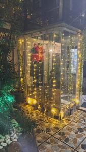 a glass greenhouse with lights on a patio at Kai Hotel in Tbilisi City