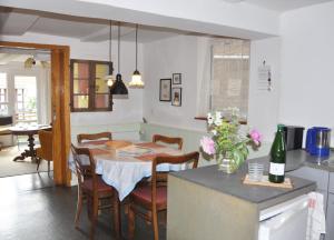 a kitchen and dining room with a table and chairs at Ferienhaus EMMA in Kleinern