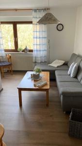 a living room with a couch and a coffee table at Haus Bergblick in Bringhausen