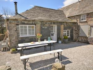 a picnic table in front of a cottage at 1 bed in Boscastle 42375 in Saint Gennys