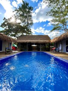 a swimming pool in front of a house at Ysla Cabins in Cabangan