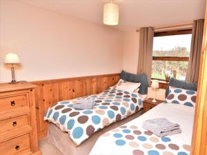 two beds in a room with a window at 2 Bed in Ledbury 77377 