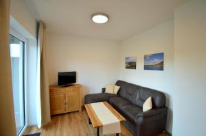 a living room with a couch and a table at Ferienappartements Pfeil in Nieder-Werbe