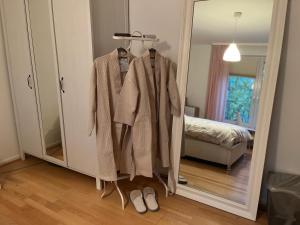a robe on a rack in a room with a mirror at Feel home in Frankfurt/Main