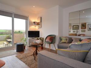 a living room with a couch and a tv at 2 Bed in Widemouth Bay 55833 in Marhamchurch