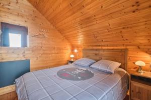 a bedroom with a bed in a wooden cabin at Le chalet Céline in Le Dévoluy