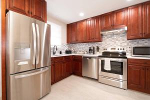 a kitchen with wooden cabinets and stainless steel appliances at Home in College Park in College Park