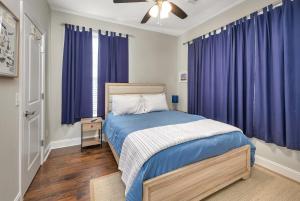 a bedroom with a bed with purple curtains at Island Retreat in Glynn Haven in Saint Simons Island