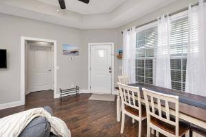 a living room with a dining room table and chairs at Island Retreat in Glynn Haven in Saint Simons Island