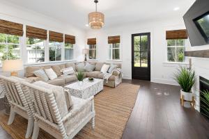 a living room with a couch and chairs and a tv at Ocean Pearl in Saint Simons Island