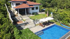 an aerial view of a house with a swimming pool at Peaceful Villa with pool near Hikkaduwa in Ambalangoda