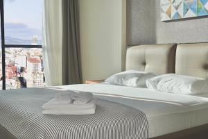 מיטה או מיטות בחדר ב-Season Suite Apart-Hotel