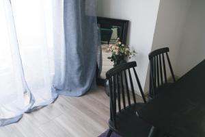a dining room with a table and two chairs and a mirror at Nippori Bristol Hotel in Tokyo