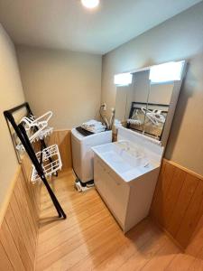 a bathroom with a sink and a large mirror at ～Fushimi Inari～露天風呂付の一棟貸切のゲストハウス in Kyoto