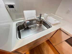 a kitchen sink with a faucet in a kitchen at ～Fushimi Inari～露天風呂付の一棟貸切のゲストハウス in Kyoto