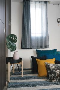 a room with blue and yellow pillows and a window at Nippori Bristol Hotel in Tokyo +45 photos