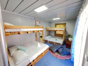 a room with two bunk beds and two pillows at Ysla Cabins in Cabangan