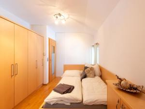 a small bedroom with a bed and a desk at Exclusive panoramic apartment in Niedernsill in Niedernsill