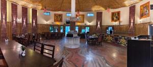 a restaurant with wooden floors and tables and chairs at Royals Moonlight Resort,Corbett in Rāmnagar