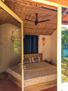 a bedroom with a bed in a tent at Cozy Wellness Cocoons in Mandrem