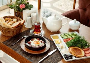 a table topped with a breakfast of eggs and bread at SAMALA Hotel Bangkok in Bangkok