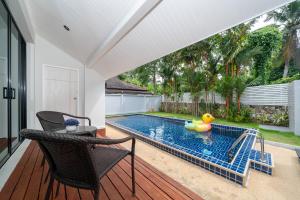a swimming pool with a rubber duck in a yard at Sanook Villas -Geng Mak Nai Harn in Rawai Beach