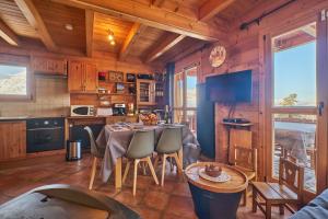a kitchen with a table and chairs in a cabin at Le chalet Sylvaine in Le Dévoluy