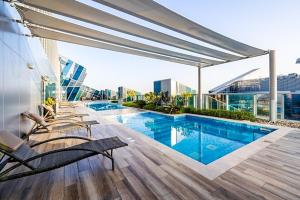 a swimming pool on the roof of a building at New Arabian 2 Bedroom J One Tower Business Bay in Dubai