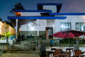 a building with stairs and tables and an umbrella at Peaceful Villa with pool near Hikkaduwa in Ambalangoda +19 photos