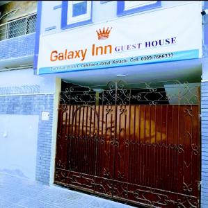 a gate in front of a guest house at Galaxy Inn Guest House in Karachi