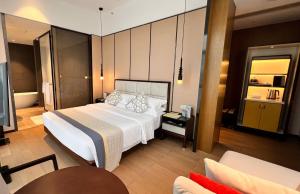 a bedroom with a large white bed and a couch at Prince Times Hotel in Sihanoukville