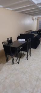 a living room with a table and chairs and a couch at 3bedrm, 2 bthrm. 7East Greater Portmore in Portmore