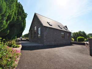 a brick house with a driveway in front of it at 2 bed in Abergavenny 65965 in Pandy