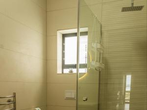 a glass shower in a bathroom with a window at Witsand Whalecliff accommodation in Witsand