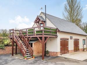 a house with a wooden staircase in front of it at 1 Bed in Hawarden 86711 in Hawarden